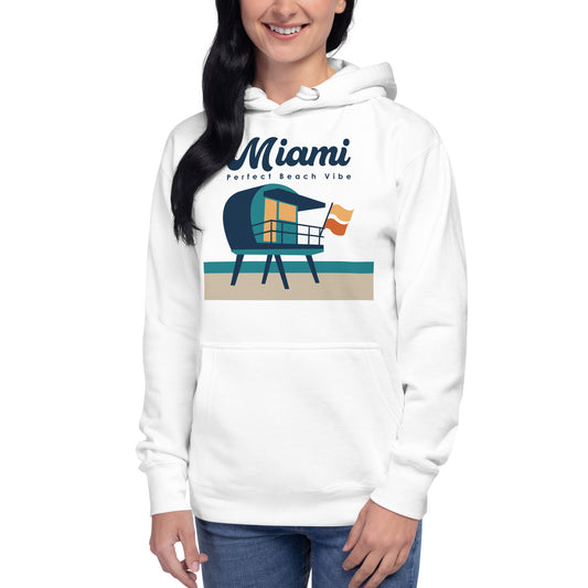 A woman smiling, wearing a white unisex hoodie with 'MIAMI BEACH VIBE' text and a graphic of a lifeguard tower on the fron