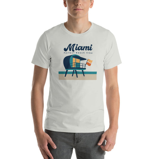 A white unisex crew neck t-shirt with 'MIAMI' printed in blue and red text on the front, featuring an illustration of a lifeguard tower.